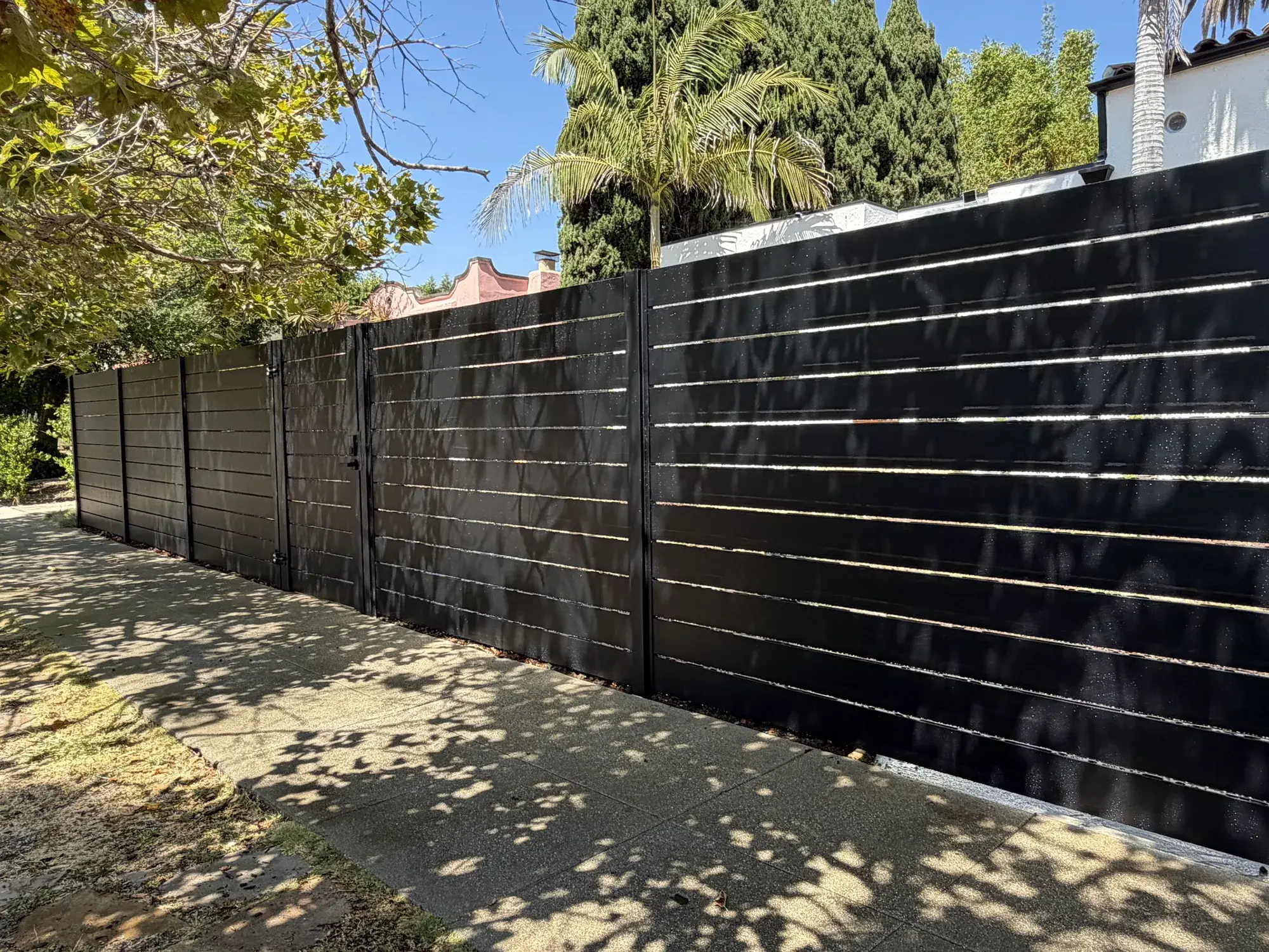 Black aluminum semi-privacy fence & motorized rolling gate in Los Angeles, CA — photo 2 of 4