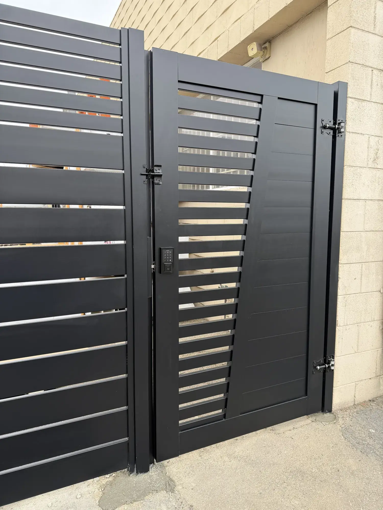 Black aluminum semi & full privacy fencing, custom gate in Top Notch shop — photo 2 of 3
