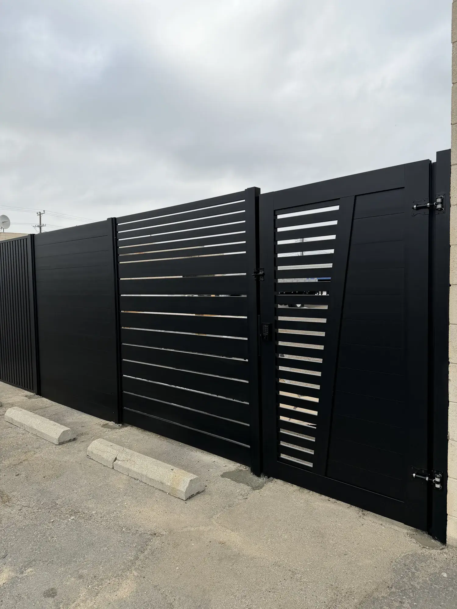 Black aluminum semi & full privacy fencing, custom gate in Top Notch shop — photo 3 of 3
