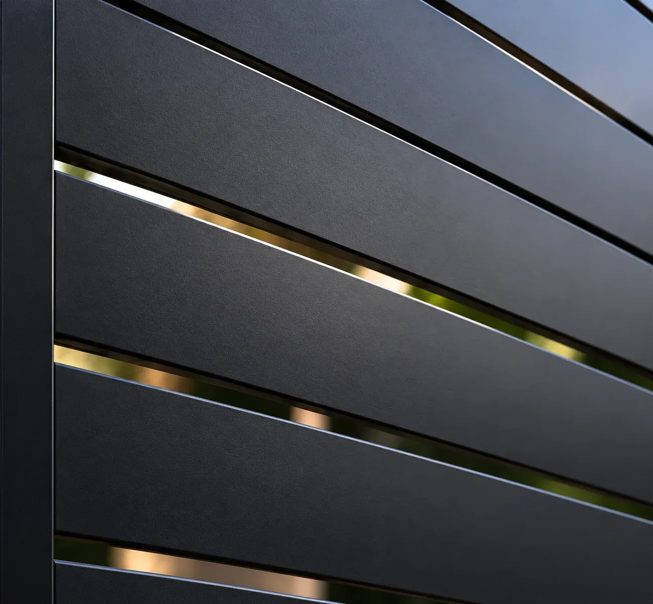 Close-up of black horizontal aluminum slats with narrow gaps between them